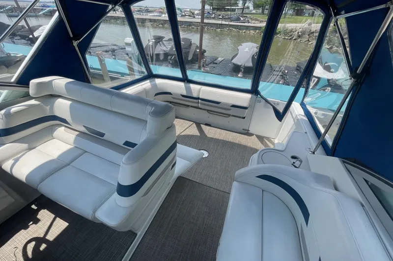 Slide: The Image of 1999 Formula 31 Performance Cruiser cockpit with steering wheel and gauges, docked at marina. - 15