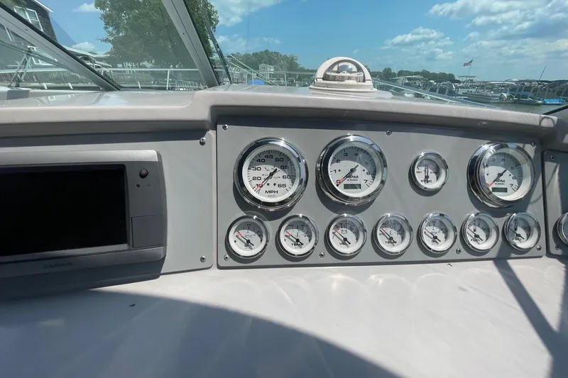 Slide: The Image of Dashboard of a 1999 Formula 31 Performance Cruiser with RPM and fuel gauges. - 19