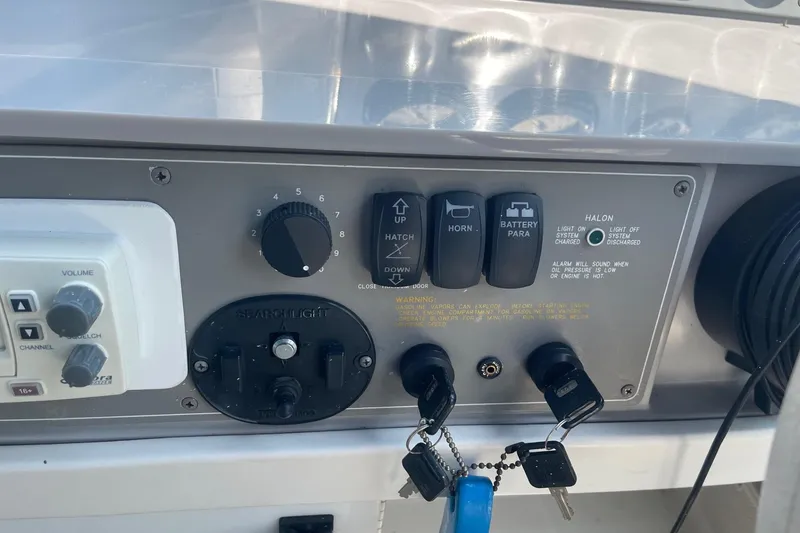 Slide: The Image of Control panel of a 1999 Formula 31 Performance Cruiser with labeled switches. - 21