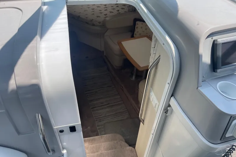 Slide: The Image of 1999 Formula 31 Performance Cruiser kitchen with sink, stove, microwave, and TV. - 25