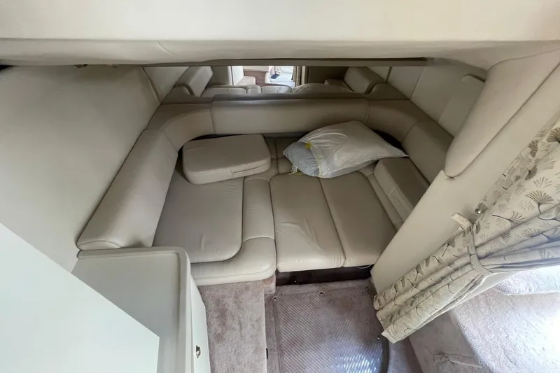 Slide: The Image of 1999 Formula 31 Performance Cruiser interior with beige seating and wooden table. - 28