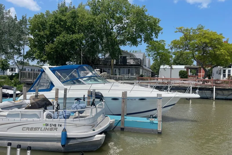 Slide: The Image of 1999 Formula 31 Performance Cruiser docked, featuring sleek white design and blue canopy. - 5