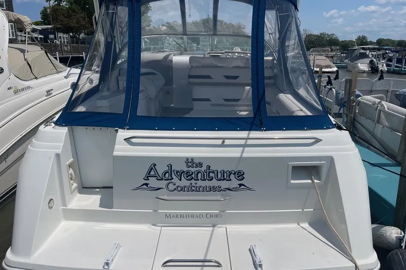 Slide: The Image of 1999 Formula 31 Performance Cruiser docked, featuring blue canopy and "The Adventure Continues" text. - 8