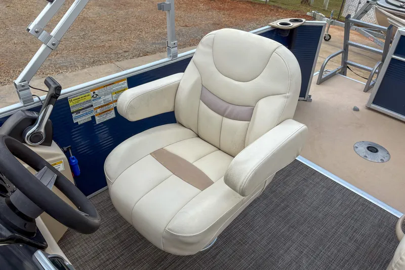 Slide: The Image of Captain's chair on 2016 Godfrey Sweetwater 2086 C pontoon boat, featuring beige upholstery. - 10