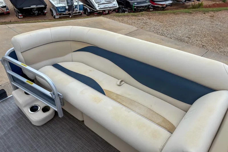 Slide: The Image of 2016 Godfrey Sweetwater 2086 C pontoon boat seating with cup holders, beige and blue upholstery. - 11