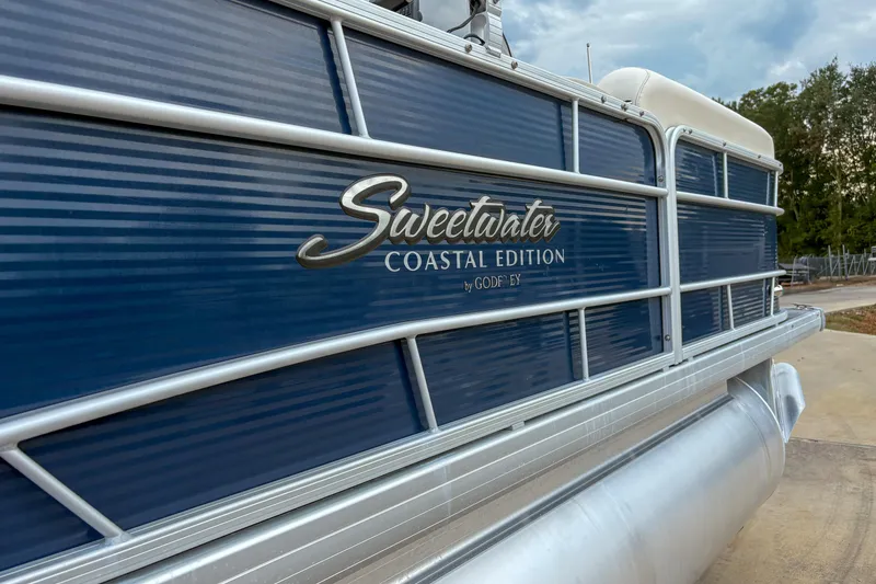 Slide: The Image of 2016 Godfrey Sweetwater 2086 C pontoon boat, blue exterior, "Coastal Edition" branding. - 5