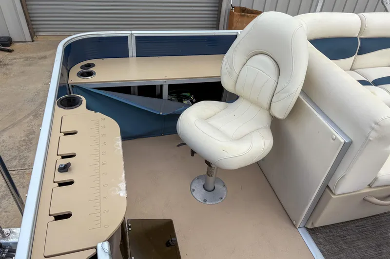 Slide: The Image of 2016 Godfrey Sweetwater 2086 C boat interior with white seating and measuring board. - 6