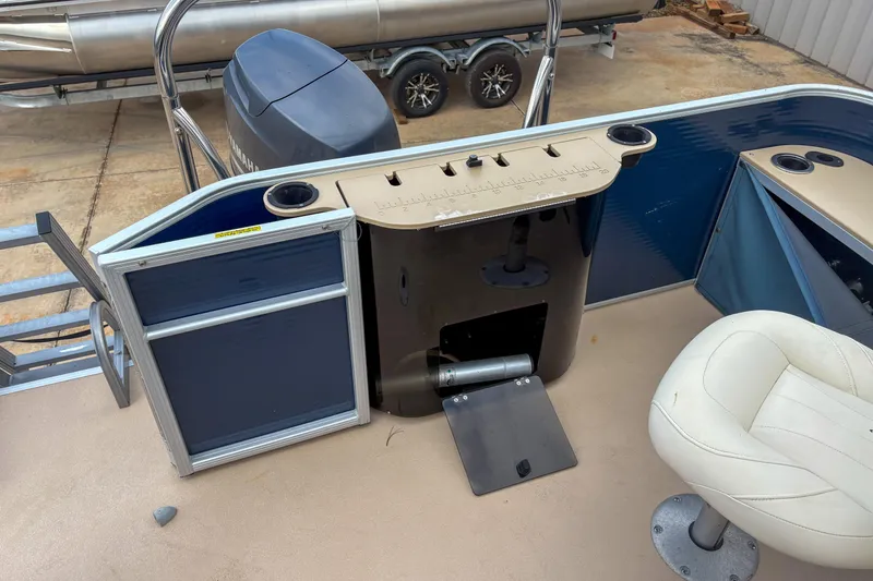 Slide: The Image of 2016 Godfrey Sweetwater 2086 C pontoon boat interior with helm, seating, and motor. - 7