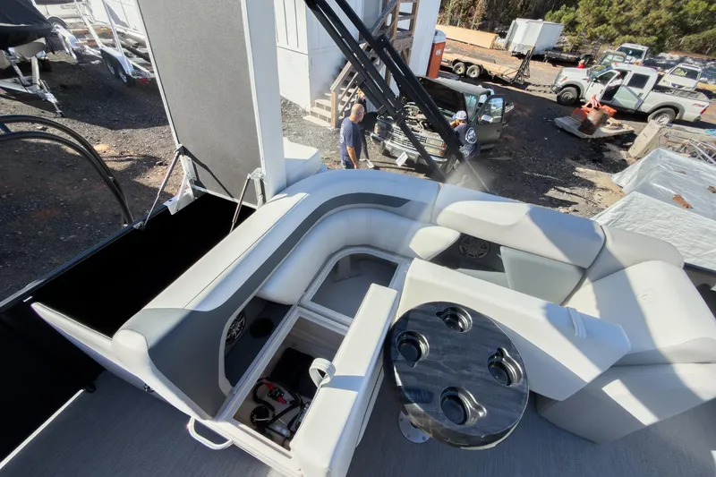 Slide: The Image of 2026 Godfrey Sweetwater 20' Cruise Tritoon interior with seating and table, outdoor setting. - 23