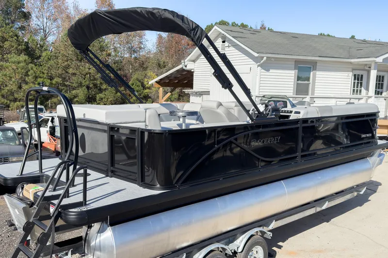 Slide: The Image of 2026 Godfrey Sweetwater 20' Cruise Special Edition Tritoon, black exterior, parked outdoors. - 3
