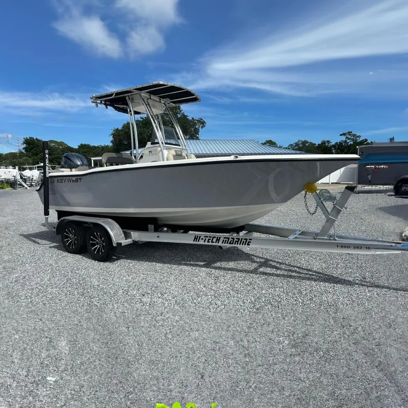 The Image of 2026 Key West 203 FS boat on trailer under clear blue sky. - 0