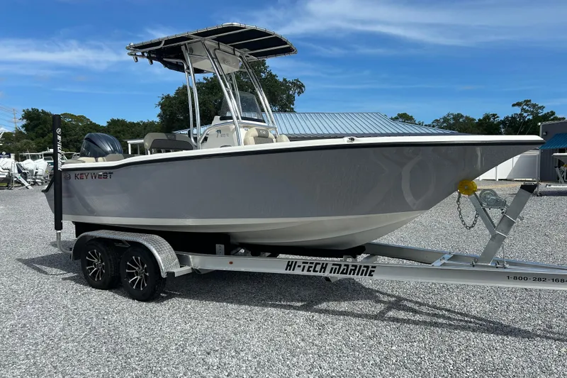 Slide: The Image of 2026 Key West 203 FS boat on a trailer in a gravel lot. - 1