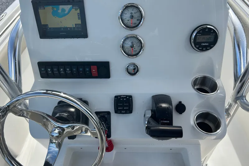 Slide: The Image of Control panel of 2026 Key West 203 FS boat with steering wheel and gauges. - 12