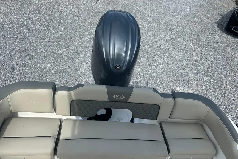 Slide: The Image of 2026 Key West 203 FS boat interior with cushioned seating and motor view. - 15