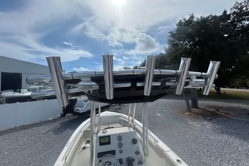 Slide: The Image of 2026 Key West 203 FS boat with rod holders and console, under a partly cloudy sky. - 17