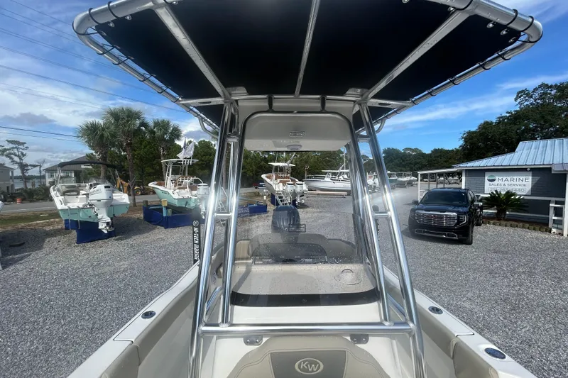 Slide: The Image of 2026 Key West 203 FS boat with T-top, displayed at a marine sales lot. - 19