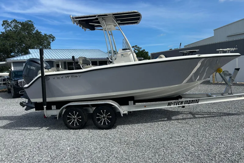 Slide: The Image of 2026 Key West 203 FS boat on trailer, parked outdoors, clear sky background. - 2