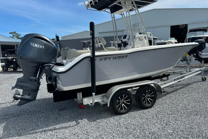 Slide: The Image of 2026 Key West 203 FS boat on trailer with Yamaha outboard motor, parked outdoors. - 3