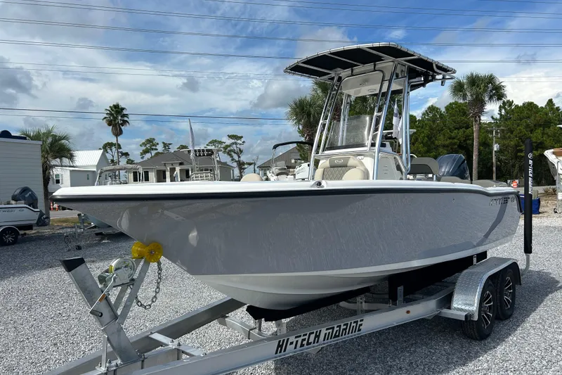 Slide: The Image of 2026 Key West 203 FS boat on trailer, parked outdoors under cloudy sky. - 5