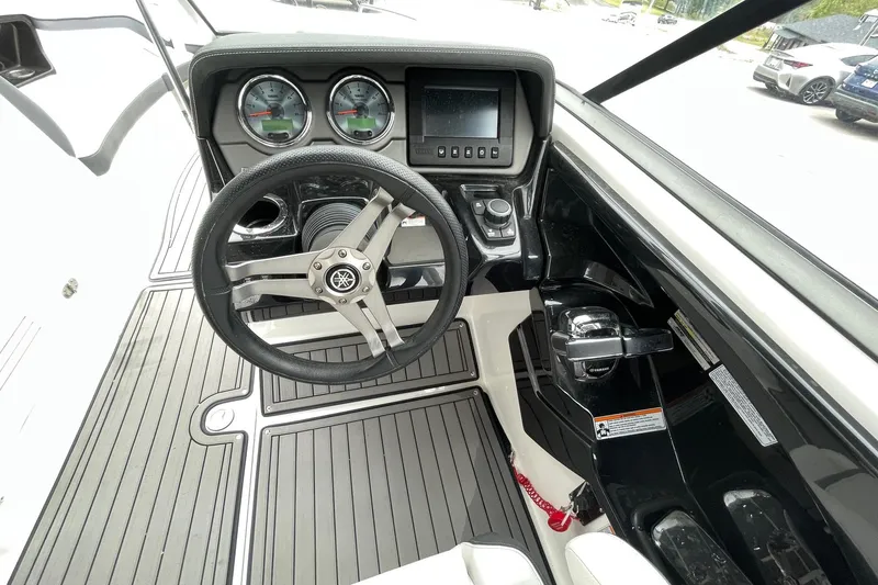 Slide: The Image of 2017 Yamaha 242 boat dashboard with steering wheel, gauges, and control panel. - 11