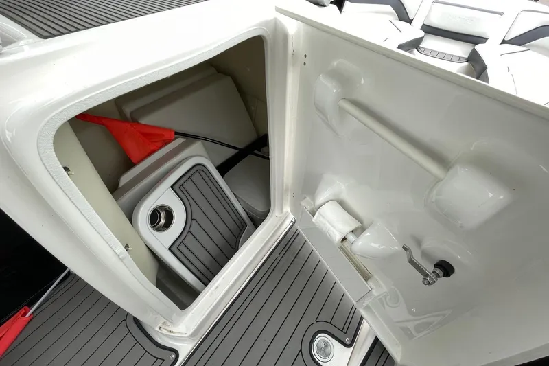 Slide: The Image of Interior storage compartment of 2017 Yamaha 242 boat, featuring a clean, organized design. - 15