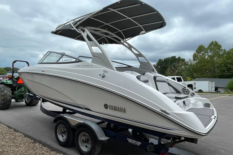 Slide: The Image of 2017 Yamaha 242 boat on trailer, sleek design, overcast sky background. - 2