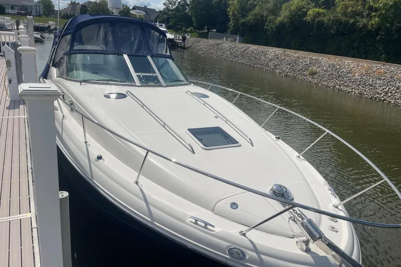 Slide: The Image of 2007 Sea Ray 320 Sundancer docked in a serene marina setting. - 1