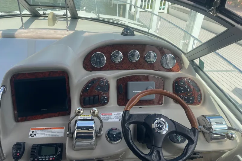 Slide: The Image of Dashboard of a 2007 Sea Ray 320 Sundancer boat with steering wheel and control panel. - 15