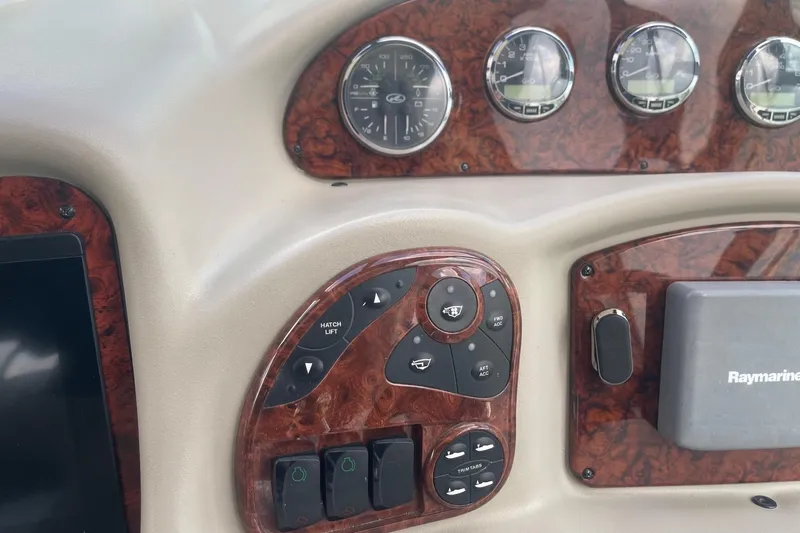 Slide: The Image of Dashboard of 2007 Sea Ray 320 Sundancer with gauges and Raymarine equipment. - 17