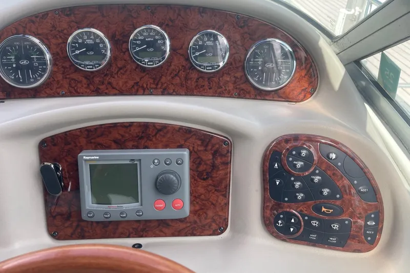 Slide: The Image of Dashboard of a 2007 Sea Ray 320 Sundancer with gauges and control panel. - 18