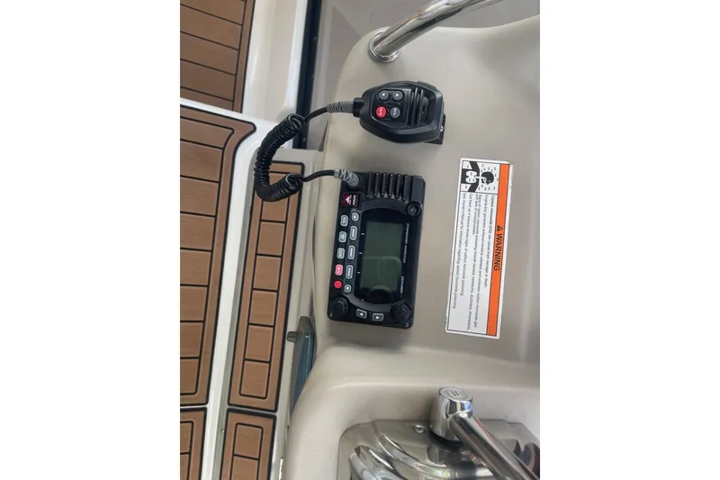 Slide: The Image of Control panel of a 2007 Sea Ray 320 Sundancer boat with radio and warning label. - 19