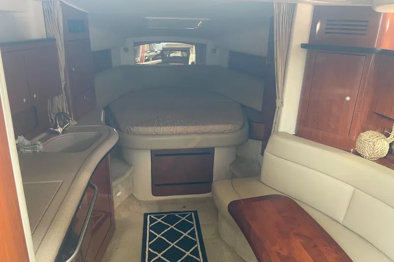 Slide: The Image of Interior of 2007 Sea Ray 320 Sundancer with cozy cabin and elegant wood finishes. - 23