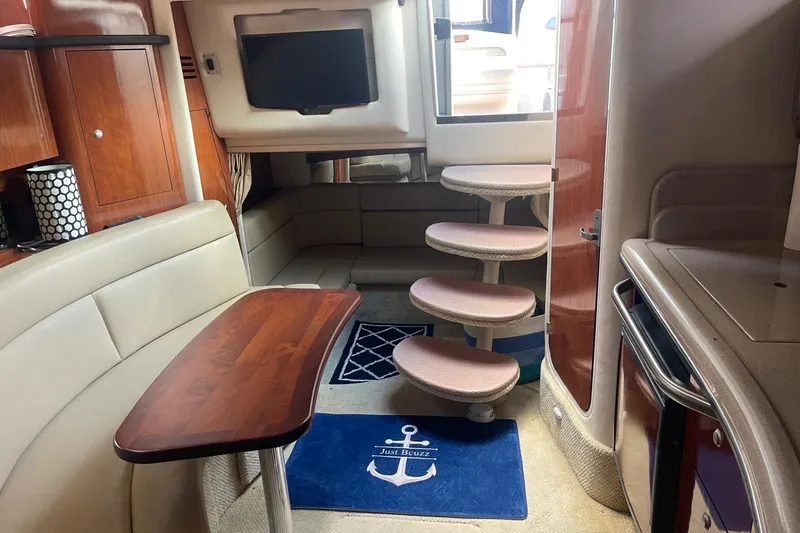 Slide: The Image of Luxurious interior of 2007 Sea Ray 320 Sundancer yacht with elegant seating and wooden table. - 25