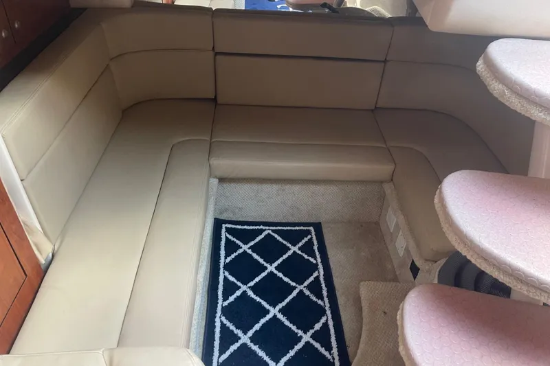 Slide: The Image of Interior of 2007 Sea Ray 320 Sundancer with beige seating and patterned rug. - 28