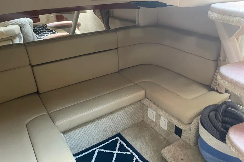 Slide: The Image of Interior of 2007 Sea Ray 320 Sundancer with beige seating and carpeted flooring. - 29