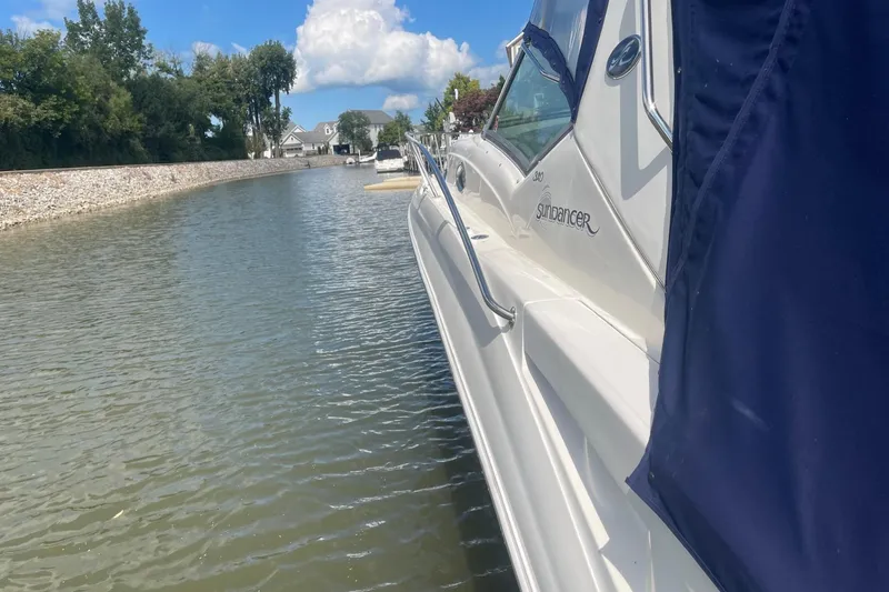 Slide: The Image of 2007 Sea Ray 320 Sundancer yacht docked in a serene canal setting. - 40