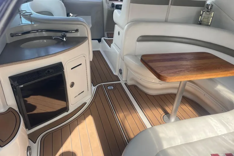 Slide: The Image of Luxurious interior of 2007 Sea Ray 320 Sundancer with wood table and kitchenette. - 5
