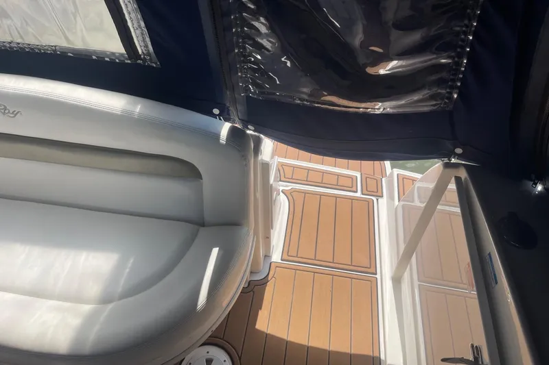 Slide: The Image of 2007 Sea Ray 320 Sundancer interior with white seating and wooden deck. - 7