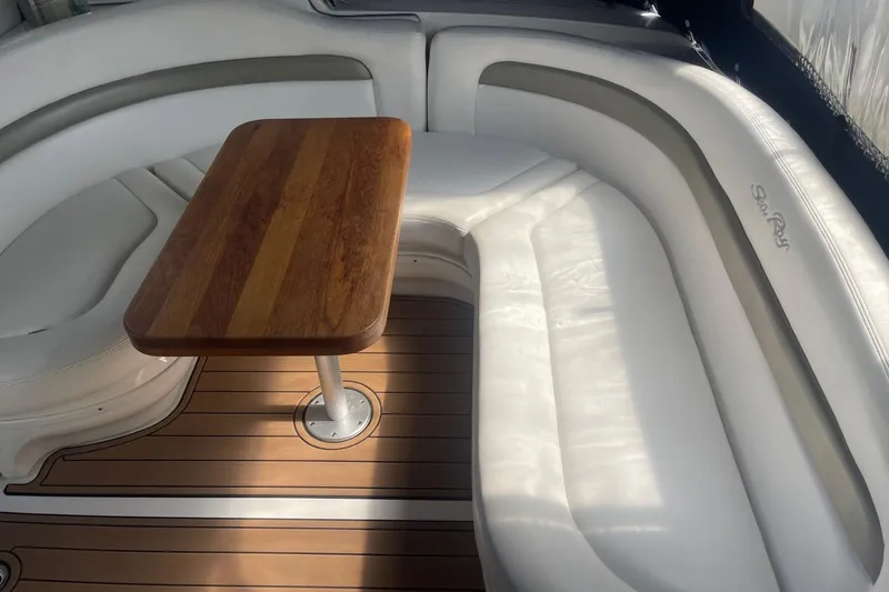Slide: The Image of Luxurious seating area on 2007 Sea Ray 320 Sundancer with wooden table and white upholstery. - 8