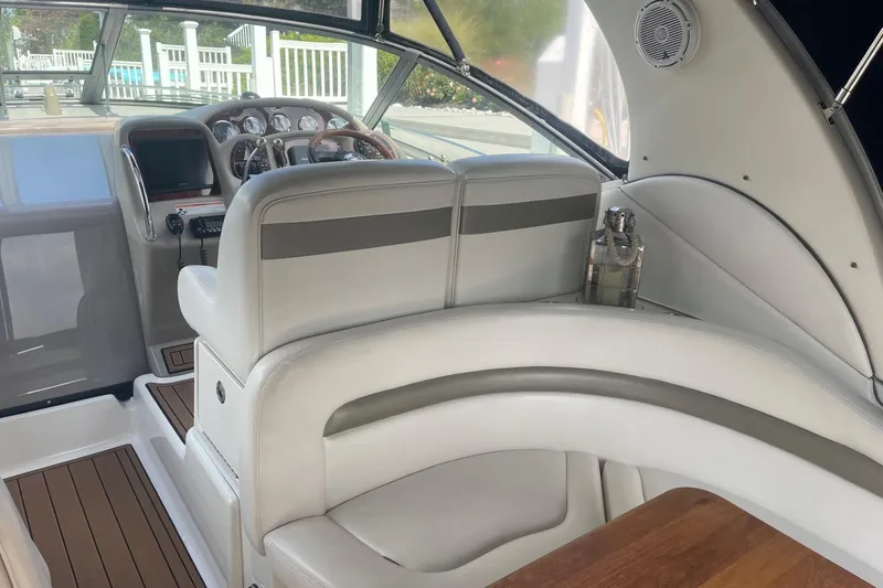 Slide: The Image of 2007 Sea Ray 320 Sundancer cockpit with leather seating and wooden accents. - 9