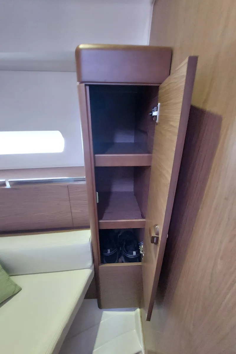 Slide: The Image of Sails of a 2013 Jeanneau Sun Odyssey 44 DS against a bright blue sky. - 100