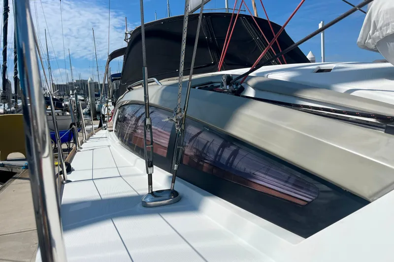 Slide: The Image of 2013 Jeanneau Sun Odyssey 44 DS sailboat docked at marina, side view. - 11