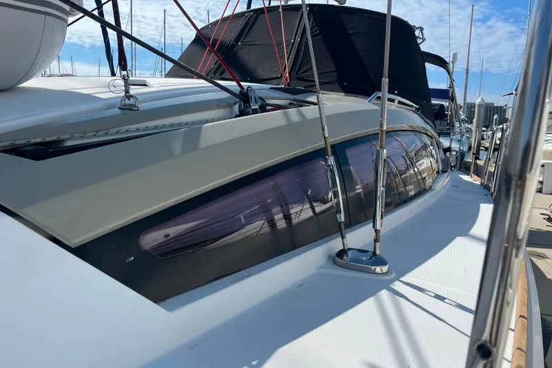 Slide: The Image of Jeanneau Sun Odyssey 44 DS 2013 yacht deck with star emblem, docked at marina. - 12