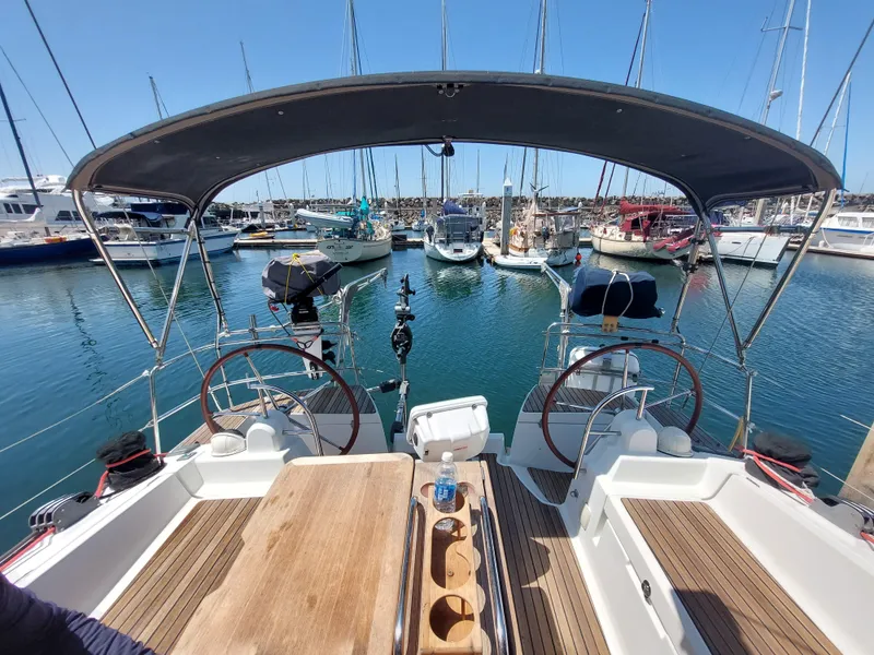 Slide: The Image of Jeanneau Sun Odyssey 44 DS 2013 yacht deck with star emblem, docked at marina. - 13