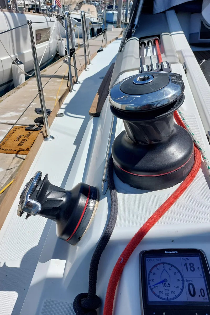 Slide: The Image of Steering wheel of 2013 Jeanneau Sun Odyssey 44 DS sailboat in marina. - 19