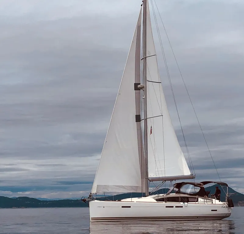 Slide: The Image of 2013 Jeanneau Sun Odyssey 44 DS sailboat docked at marina under clear blue sky. - 2