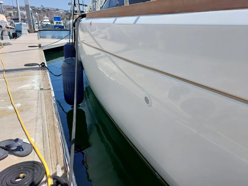Slide: The Image of 2013 Jeanneau Sun Odyssey 44 DS sailboat docked at marina, clear sky, calm waters. - 36