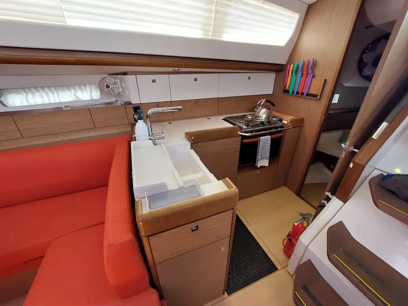 Slide: The Image of Jeanneau Sun Odyssey 44 DS sailboat, 2013 model, docked with visible rigging and equipment. - 43