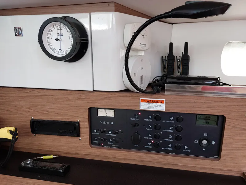 Slide: The Image of 2013 Jeanneau Sun Odyssey 44 DS sailboat deck with covered equipment, docked in marina. - 48