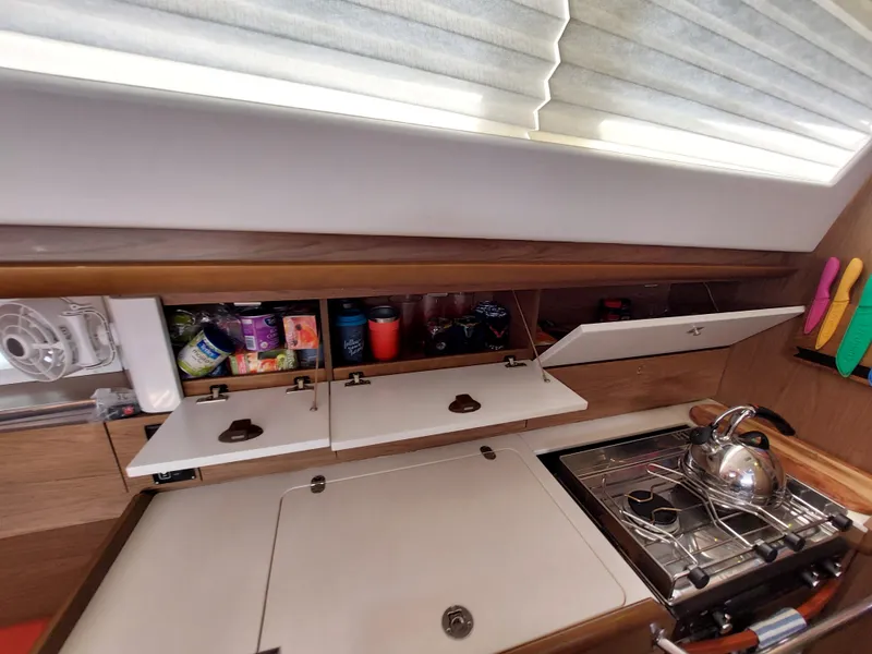 Slide: The Image of Interior of 2013 Jeanneau Sun Odyssey 44 DS with orange seating and wooden accents. - 51
